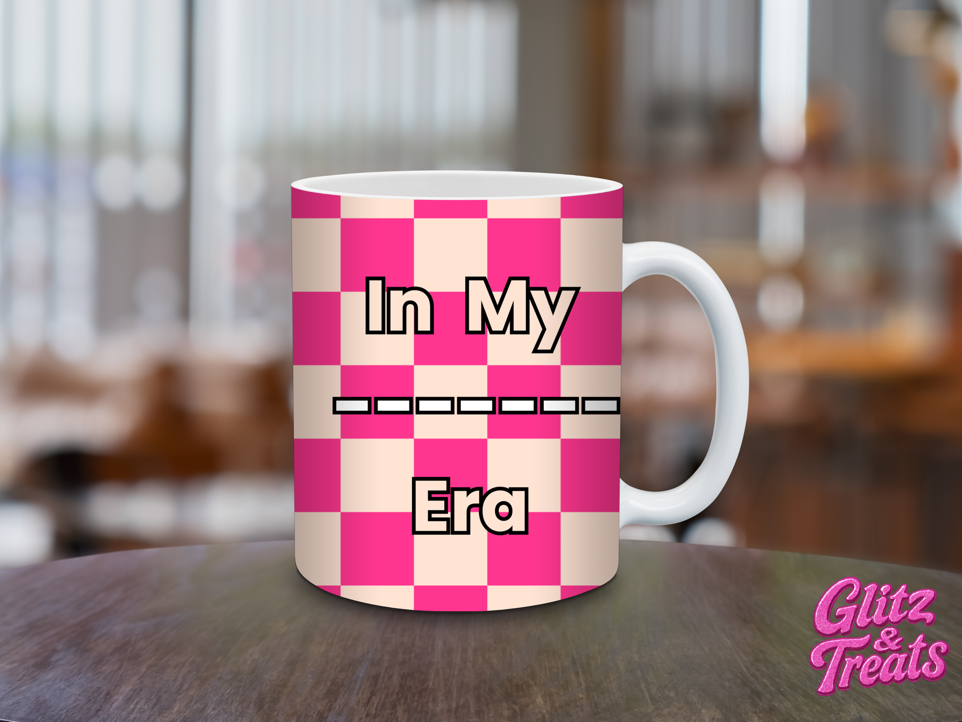 Pink and white checkered mug with text on a blurred background